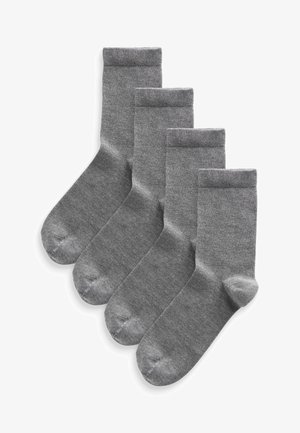 Quatre paires de chaussettes grises en matériau tricoté doux avec un poignet côtelé classique. Elles présentent une texture lisse et une pointe renforcée.