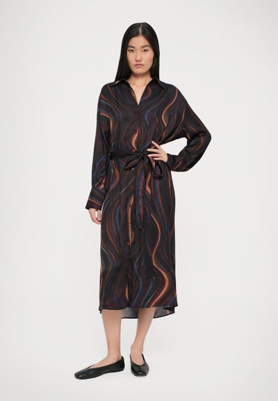Vestido preto com padrões de ondas multicoloridos. Apresenta um fecho de botão, mangas longas e um cinto combinando na cintura.