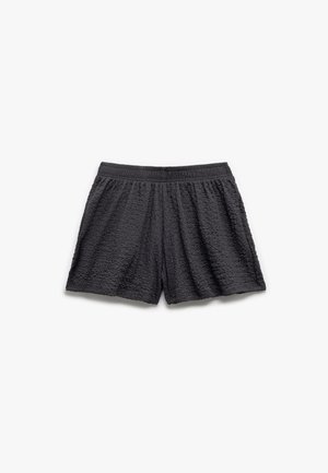 Schwarze, strukturierte Shorts mit elastischem Bund und lockerer Passform, ausgestattet mit einem gekreppten Stoffmuster und einer Länge bis zur Mitte des Oberschenkels.