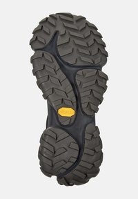 Gumowa podeszwa z wyraźnym wzorem bieżnika, z logo Vibram w kolorze żółtym, zaprojektowana z myślą o przyczepności i trwałości w aktywnościach na świeżym powietrzu.