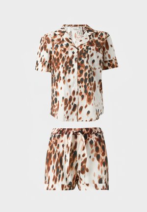Short-sleeve button-up shirt and matching shorts with brown, black, and white abstract spotted pattern on a light background.