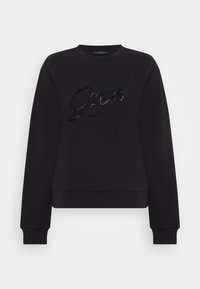 Czarna bluza z miękkiego materiału, z wyhaftowanym, cekinowym logo "Guess 1981" na środku. Rybaczane mankiety i dół.