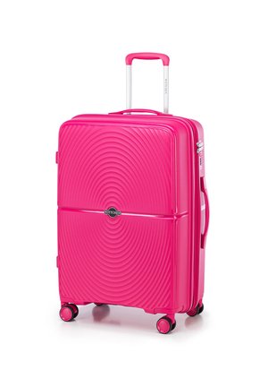 Pink hard-shell suitcase with a wavy design, retractable handle, four wheels, and a side handle for easy transport.