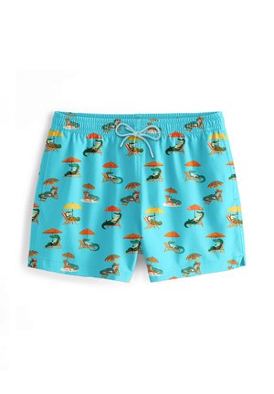 Uimaräpylät vaaleansinisinä, nopeasti kuivuvasta materiaalista, joissa on leikkisä koko painettu kuvio loikoilevista krokotiileista ja sateenvarjoista.