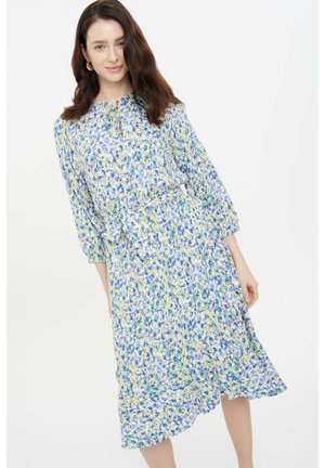 Bloemenjurk in blauwe, gele en lavendelpatronen. Zachte pasvorm met een strik taille, lange mouwen en een vloeiende zoom. Lichtgewicht stof.