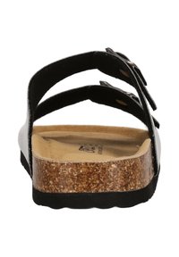Svart sandal med korksula, med dubbla justerbara remmar. Slät ovansida, formad fotbädd och en strukturerad sula för bra grepp.