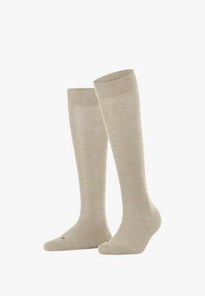 Knee-high socks in light beige, smooth texture, reinforced toe and heel, ribbed top band for secure fit, suitable for various occasions.