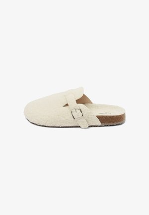White fluffy slipper featuring a wide opening, a textured upper, single adjustable strap with a silver buckle, and a cork sole.
