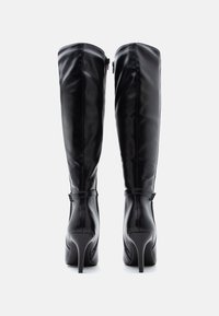 Black leather knee-high boots with a glossy finish, curved shape, stiletto heel, and side zipper detail for easy wear.