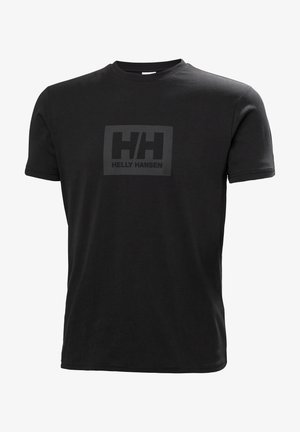 T-shirt en coton noir à manches courtes avec un logo mat au centre, portant l'inscription "HELLY HANSEN" dans un encadrement rectangulaire.