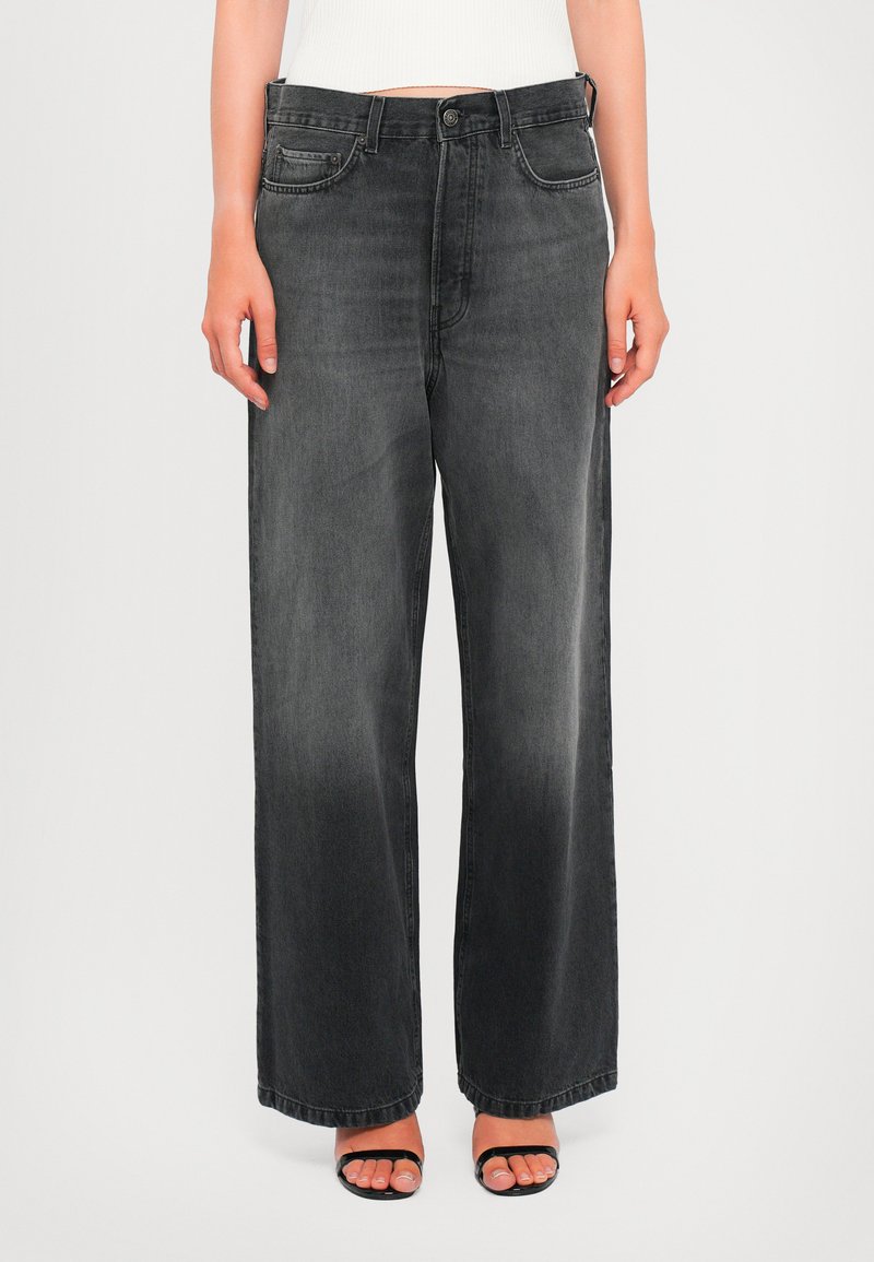 Wide-leg black denim jeans with a faded finish. Features five pockets and a button closure. Smooth texture, casual design.