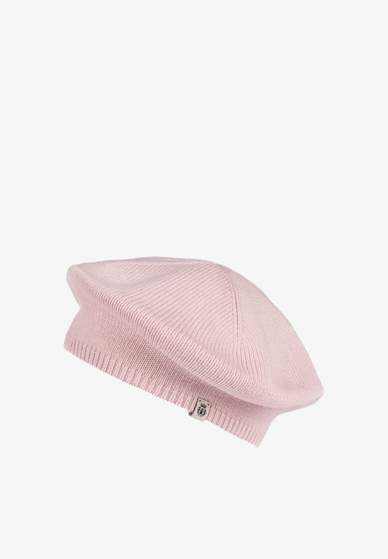 Light pink knitted beret with a small fabric tag featuring a logo on the ribbed edge.