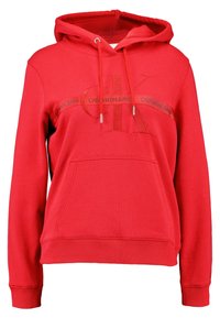 Felpa con cappuccio rossa con tasca frontale, cappuccio con coulisse regolabile e logo Calvin Klein Jeans ricamato sul petto. Tessuto in misto cotone.