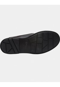 Suola nera della scarpa con motivi di battistrada geometrici, il nome del marchio "Camper" e la taglia "38" stampati nella zona centrale della suola.