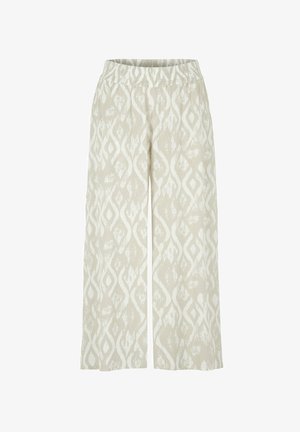 Beige bukser med vidde ben og elastik i taljen med hvidt abstrakt diamantmønster over hele stoffet.