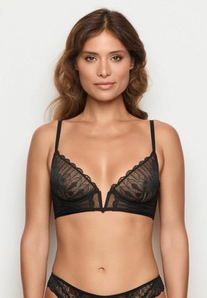 Black lace bralette with plunge neckline, scalloped edge, and delicate floral pattern. Features adjustable straps and a V-shaped underband.