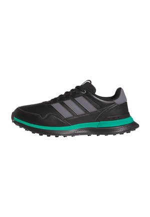 Schwarzer Sportschuh aus Leder mit grauen Streifen und Fersendetail, grüner Zwischensohle und schwarzer strukturierter Sohle, seitlich betrachtet.