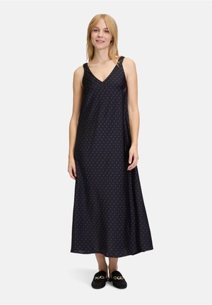 Navyblaues ärmelloses Maxikleid mit V-Ausschnitt, das mit kleinen orangen Punkten und Bändern verziert ist. Glattes Material mit fließender Silhouette.