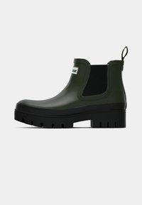 Bota Chelsea verde à prova d'água feita de borracha, com um painel lateral elástico preto e uma sola preta robusta com ranhuras.