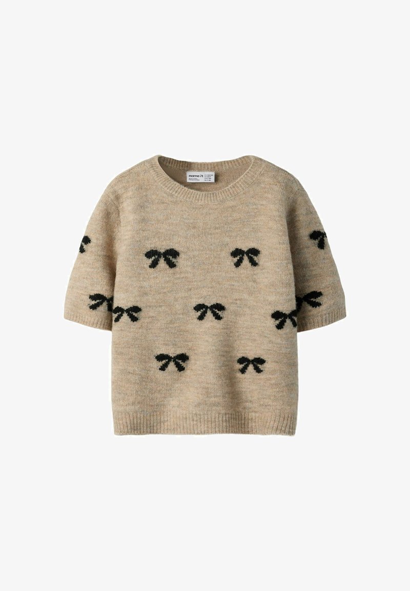 Pull en maille beige à manches courtes avec motifs de nœuds noirs dispersés sur le devant et les manches, col rond.