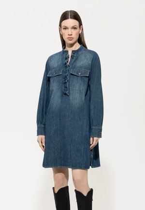 Denim dress with a buttoned, ruffled neckline, long sleeves, and chest pockets. The fabric has a medium wash and a loose fit.