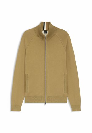 Camelkleurig jack met ritssluiting, een hoge kraag, geribbelde accenten, zijzakken en een gladde textuur. Heeft een zwart-witte streep aan de binnenkant van de kraag.