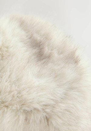 Runder, plüschiger Kunstfellstoff in hellem Cremeton, mit einer weichen, dichten Textur, die subtile Variationen und ein flauschiges Aussehen aufweist.