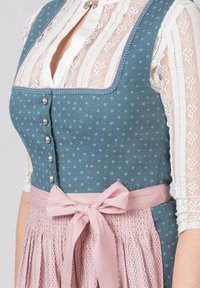 Traditional dirndl featuring a teal bodice with white floral patterns, silver buttons, and a pink skirt with pleats and a matching tie.
