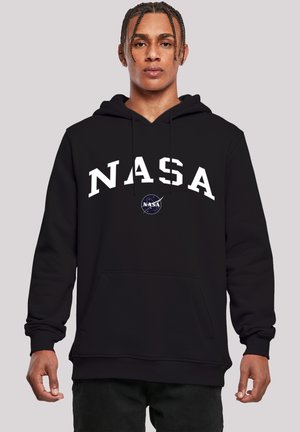 Black hoodie featuring a large white "NASA" logo across the chest. Includes a front pocket and ribbed cuffs. Circular NASA patch on front.