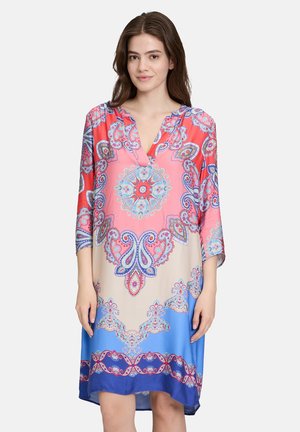 Multicolored dress featuring a paisley pattern, V-neckline, ¾ sleeves, and a loose fit with a gradient blue hem. Made from a light fabric.