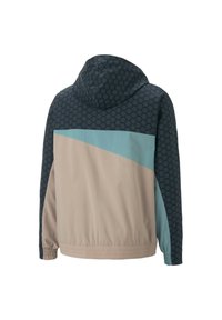 Chaqueta con capucha que presenta un patrón hexagonal en azul oscuro, con un diseño de bloques de color en azul claro y beige. Tejido ligero con dobladillo elástico.