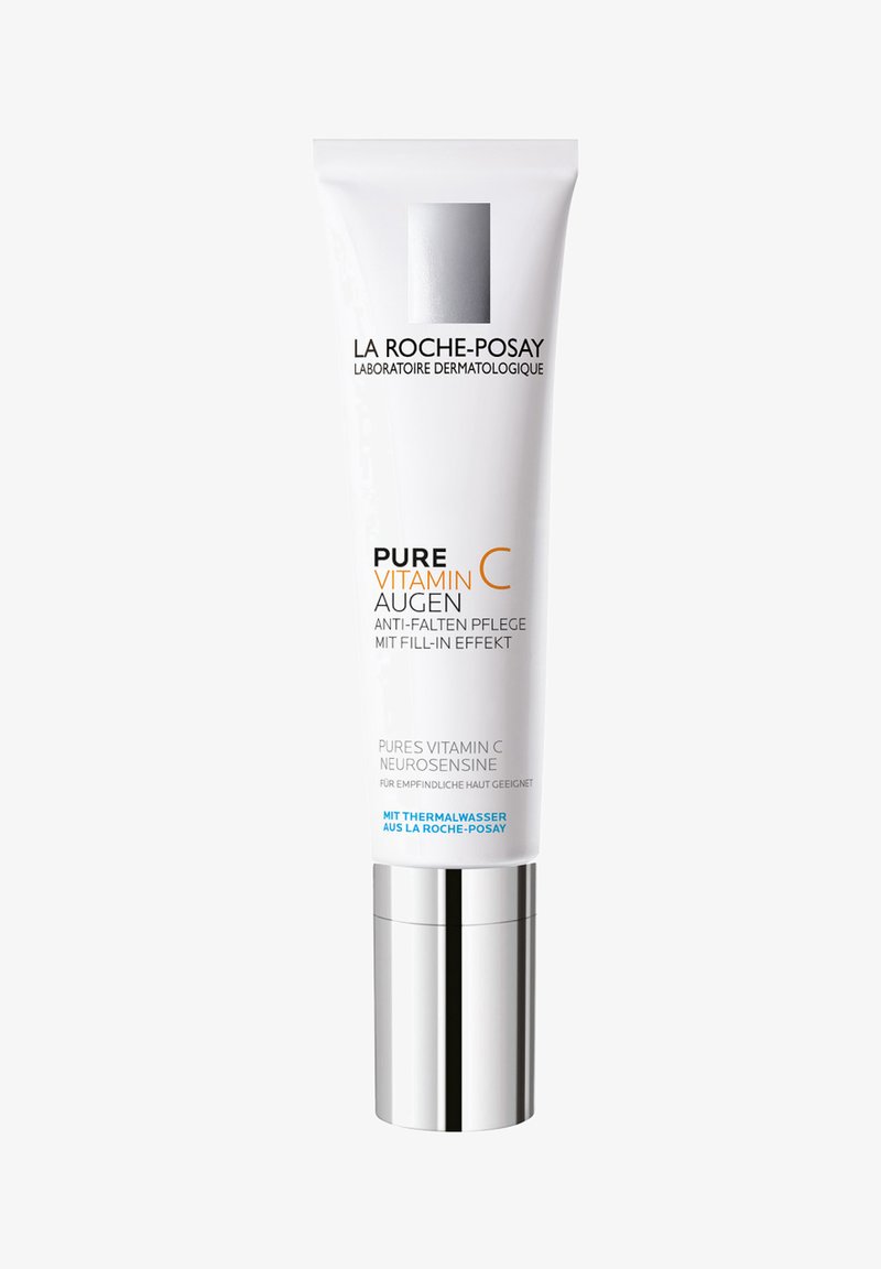 White plastic tube of Pure Vitamin C eye cream with silver pump base. Features product name and details in black and orange text.