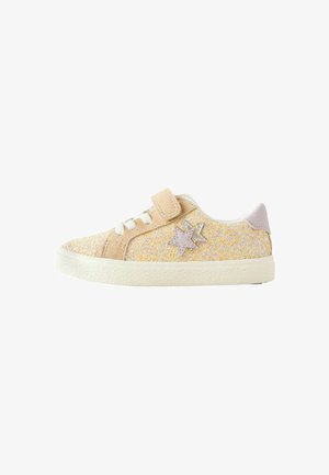 Glittery beige sneaker with a velcro strap and white laces. Features a light purple star accent and a textured white sole.