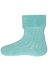 Türkise gestrickte Socke mit gerippter Textur, ausgestattet mit einem umgeschlagenen Bündchen und glatter Oberfläche. Entwickelt für Komfort und Wärme.