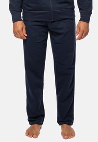 Marineblauwe joggingsbroek van zachte stof, met zijzakken en een recht model, met een gladde textuur en nette stiksels.