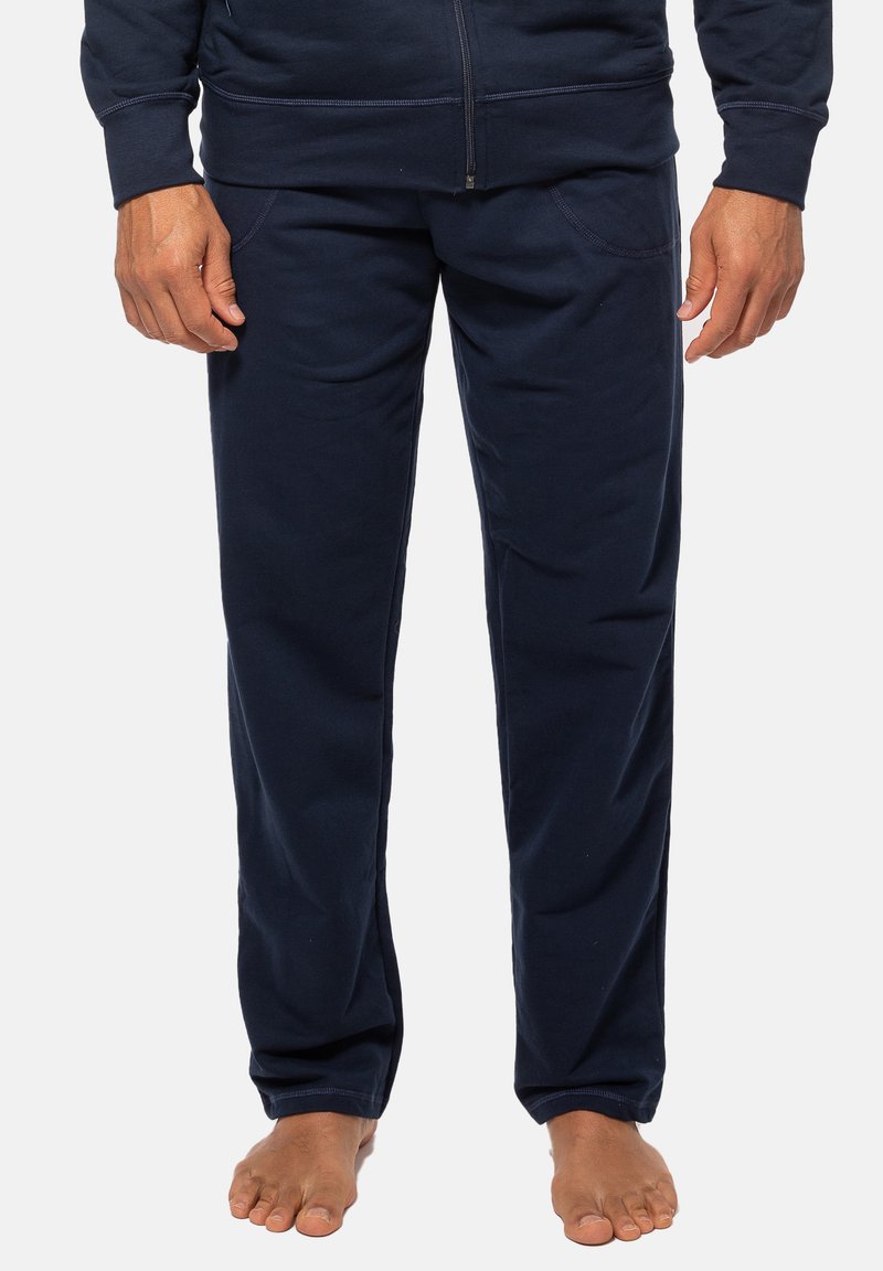 Marineblå sweatpants lavet af blødt stof, med sidelommer og lige ben-design, med en glat overflade og pæne syninger.