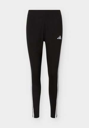 Schwarze Sportleggings mit weißen Seitenstreifen und einem weißen Adidas-Logo am oberen Oberschenkel vor einfarbigem Hintergrund.