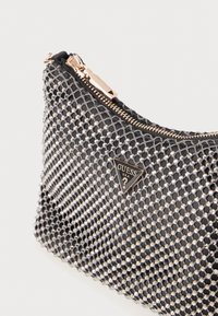 Black mesh handbag with a textured surface, featuring metallic accents and a zip closure. Notable triangular logo in rose gold.