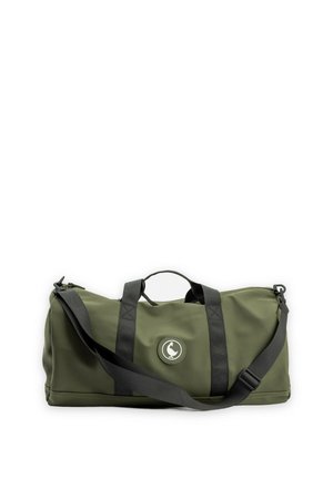 Bolsa de lona verde oliva con correas negras y correa de hombro ajustable, que muestra un logotipo circular con un pato blanco.