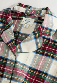 Plaid flannel shirt featuring green, red, blue, and cream colors with a notch collar, button closure, and a label indicating size and brand.