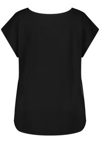 Blouse noire à manches courtes avec col rond et coupe ample, tissu lisse et ourlet légèrement arrondi en bas.