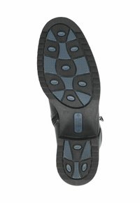 Suela de goma negra con acentos texturizados azules, que presenta múltiples patrones de agarre y un zipper en el lateral para un fácil acceso.