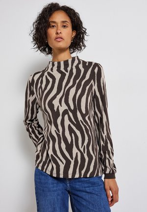 Maglia a maniche lunghe in beige chiaro con strisce zebrate scure, con collo alto e vestibilità rilassata, realizzata in tessuto morbido.