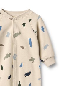 Beige-asuinen pehmeästä kankaasta, jossa useita eläinhahmoja vihreänä, sinisenä ja ruskeana. Varustettu napituksella ja resorilla varustetuilla hihoilla.