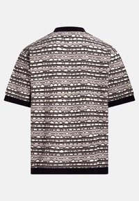 Short-sleeve top with a patterned fabric featuring cream and black horizontal stripes, and a black collar trim.
