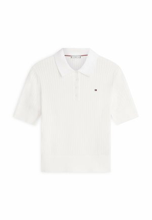 Polo a maniche corte in maglia bianca con motivo testurizzato, patta con bottoni e piccolo logo Tommy Hilfiger sul petto a sinistra.