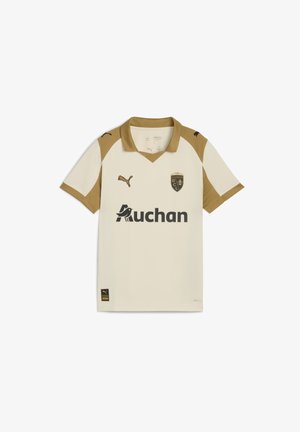 Polo shirt crema con accenti dorati e logo PUMA. Presenta scollo a V, maniche corte e testo "Auchan". Il badge mostra "RCL" e 120 anni.