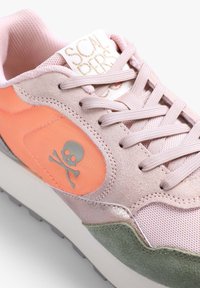 Sneaker with pink suede and mesh upper, orange accents, silver skull logo, and white sole with gray tread. Features textured overlays and laces.