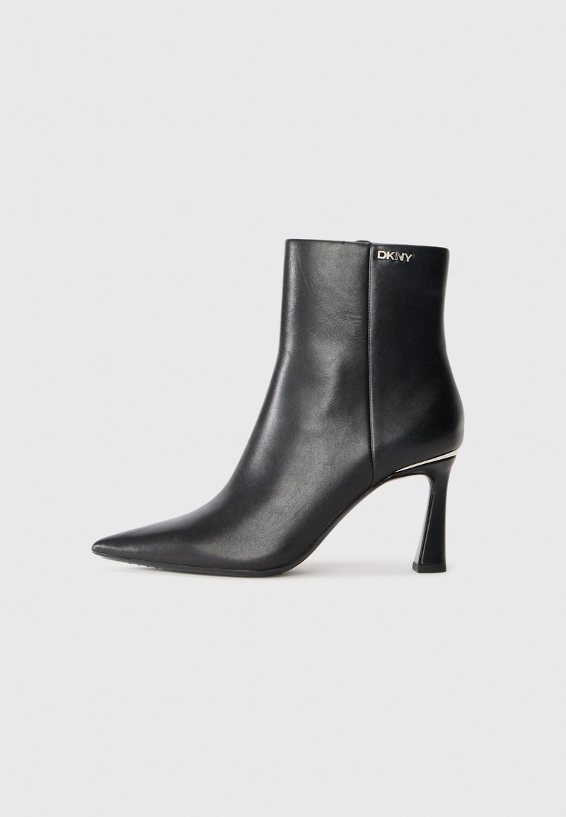 Black leather ankle boot with pointed toe, high slim heel, and small silver DKNY logo near the top edge.
