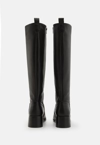 Black leather knee-high boots with a smooth finish, rounded toes, and block heels. Features a side zipper and pull tabs at the top.